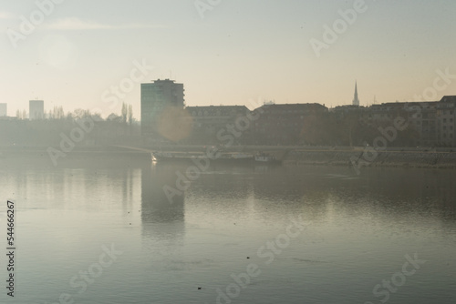 A panoramic view of the buildings next to the Danube River. Buildings by the Danube in winter, illuminated by the sun.