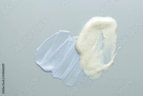 Assortment of cosmetic mask or cream balm and cleansing foam on gray background. Skin careproducts textures photo