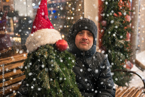 Man with fir tree decorated...