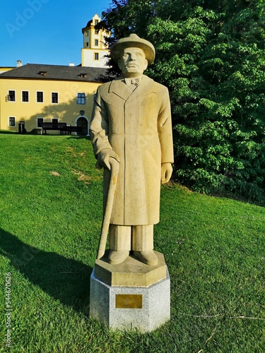 Statue of Count Jaroslav Sternberg, in the background Malenovice Castle, Zlin Region, Malenovice photo
