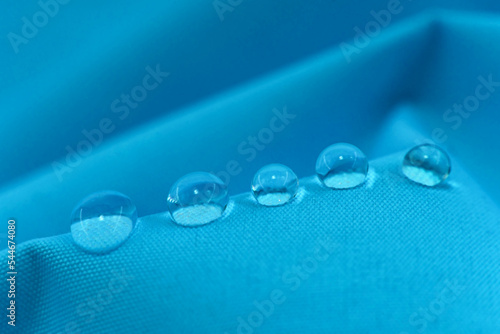 Drops of water on textiles. Waterproof fabric with drops on the surface