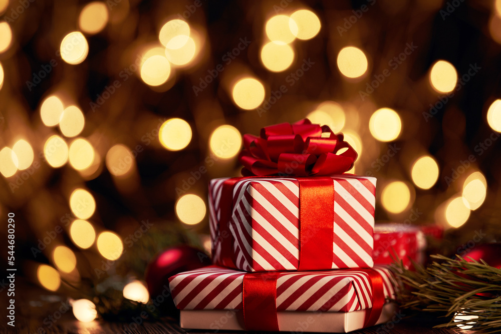 boxes with Christmas gifts on a festive background.