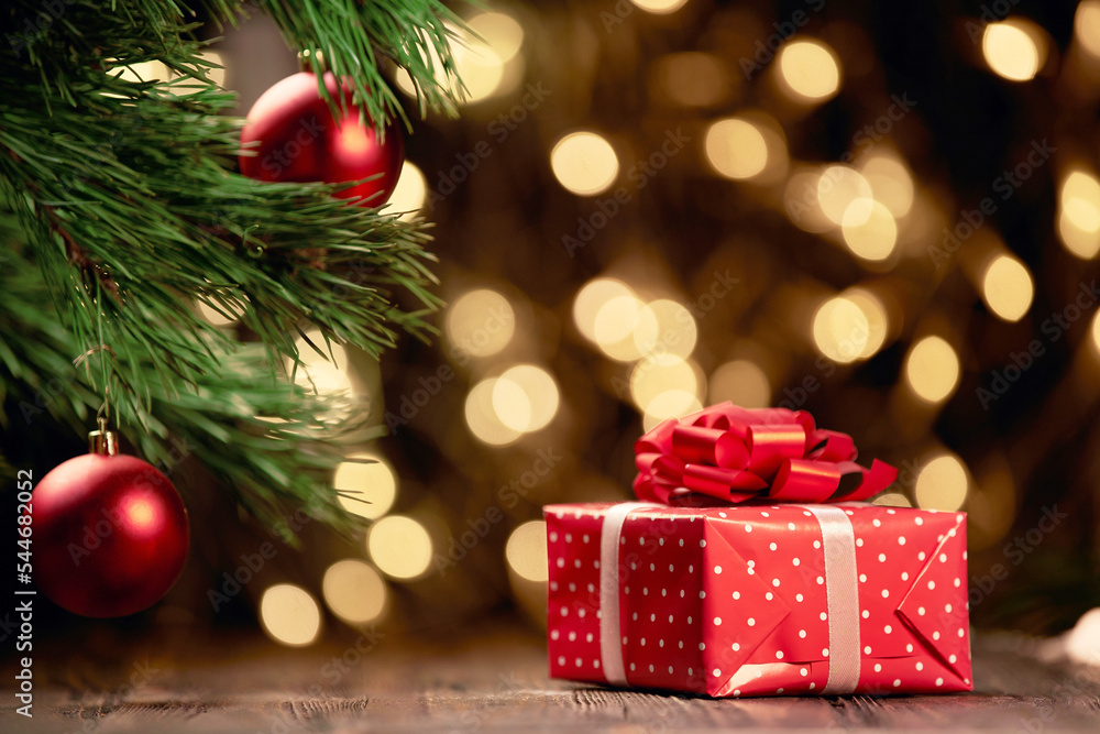 red Christmas box on a festive background.