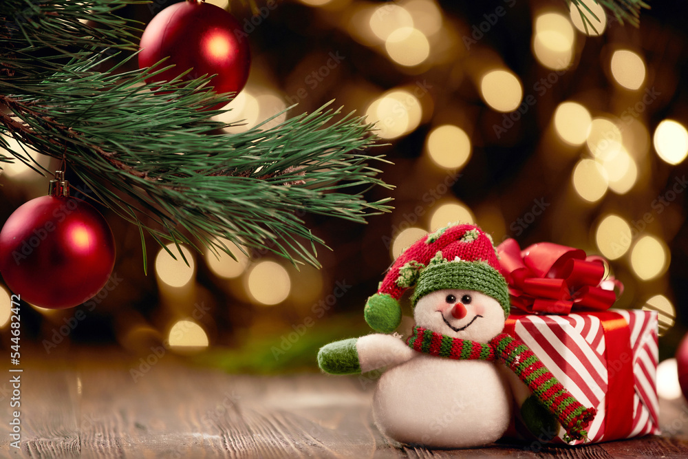 cheerful snowman and boxes with Christmas presents on a festive background. cheerful snowman and boxes with Christmas presents on a festive background.