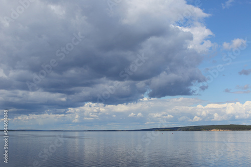 Clouds in the sky over the river © IvSky