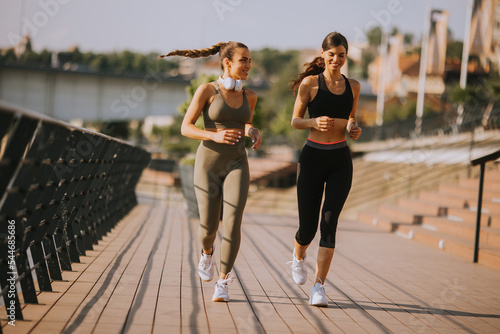 Young woman taking running ...
