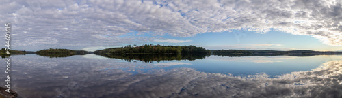 Sunrise over Ladoga lake landscape with cloudy sky panorama