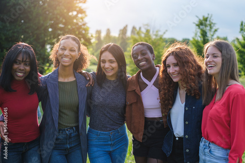 Group of young women with different cultures together outdoors at sunset in a park © Ivan