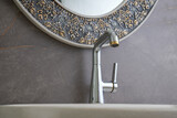 Interior of bathroom with sink basin faucet. Open chrome faucet washbasin. Modern design of bathroom,Modern and elegant 

