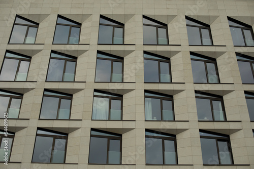 Windows in building are textured. Modernist style in architecture. Repeating element.
