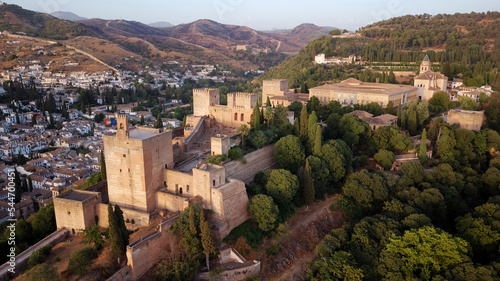 Aerial drone view of the Alhambra Palace, Granada during sunset. Moorish Architecture. Unesco World Heritage Spain. Travel in time and discover history. Amazing destinations for holidays. 
