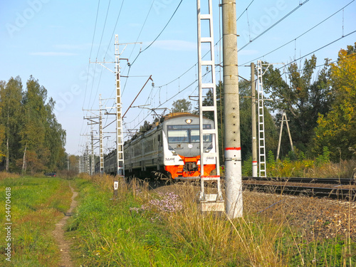 suburban trains in the Moscow region pass by villages in the summer