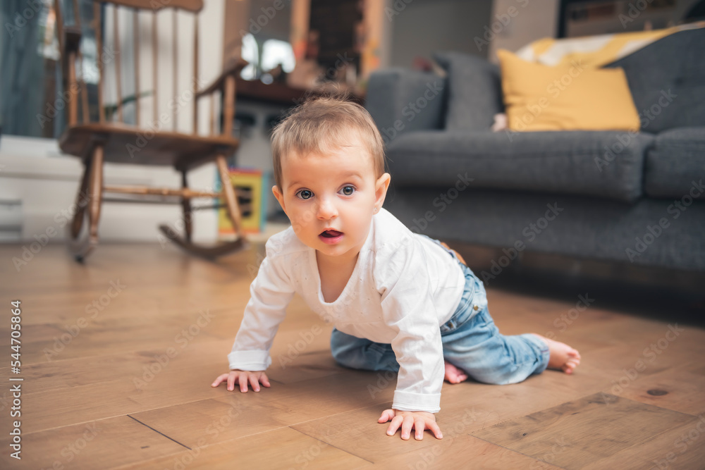 baby 9 months old learns to crawl at home. baby crawling on the floor