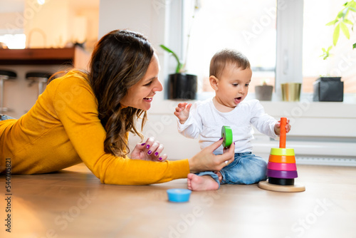 Adorable Infant Baby Playing At Home Living Room play whth her mother