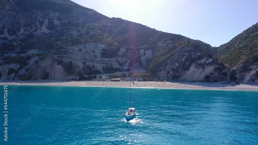 Aerial drone video of paradise beach of Myrtos with crystal clear turquoise sea surrounded by steep cliffs