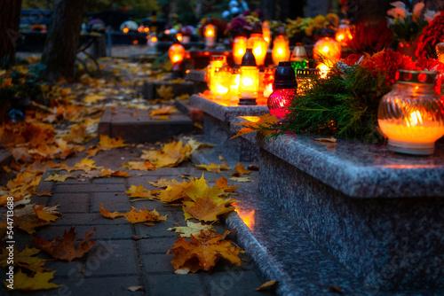 Obraz na plátně Colorful candles on the cemetery at All Saints Day, Poland