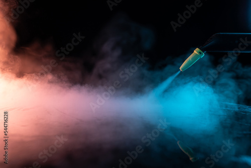 steam cleaning concept. steam on black background © stenkovlad