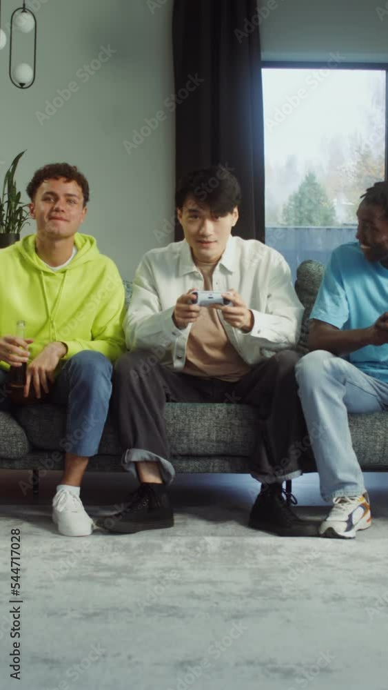 Three young men playing video games together Three young men playing video games together