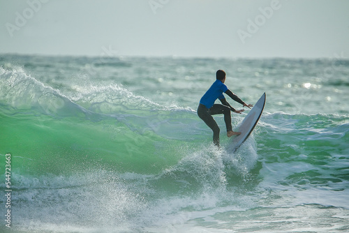 Quadro su tela Gorgeous view on urfer ride the wave,  many splashes in sunbeams  on Atlantic co