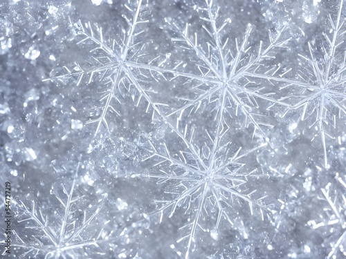 A snowflake crystal is lying on a bed of frost, sparkling in the light. Its delicate structure is magnified by the closeup lens, revealing its intricate beauty. © dreamyart