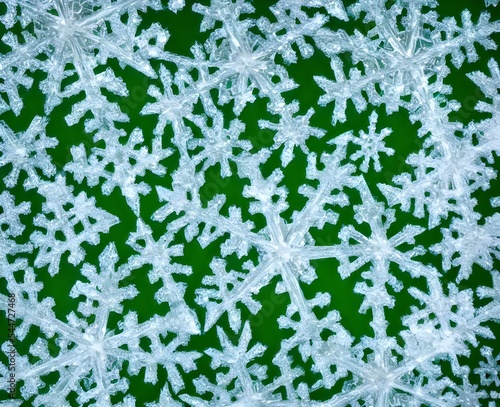 A snowflake crystal is close up and in focus. It's intricately designed pattern is on full display. The macro lens allows the viewer to see details that would normally go unnoticed.