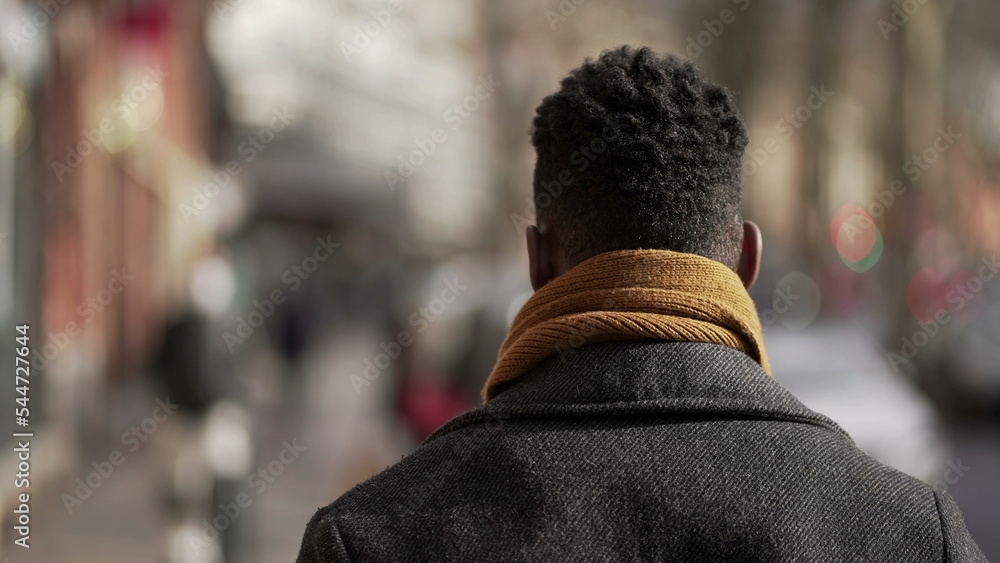 Back of black man walking outside in city Back of black man walking outside in city