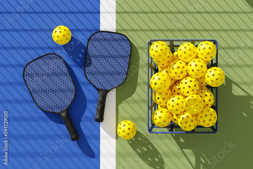 Two Pickleball paddles and basket of balls on court under the shadow of the grid. Top view. 3d illustration, render. photo