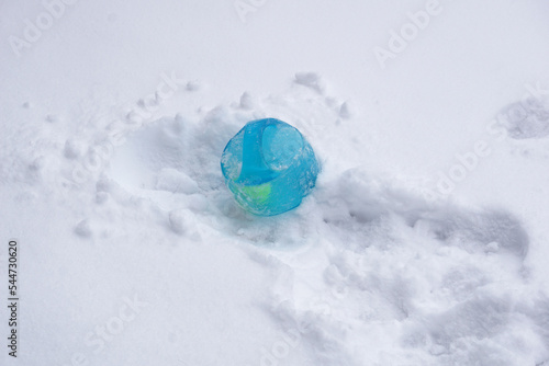 blue bouncy ball pet toy large dog toy noisy loud toy ball outside frozen in snow light blue tennis ball inside handles dog tug toy for big dogs winter time fun ball outside in snow frozen winter snow