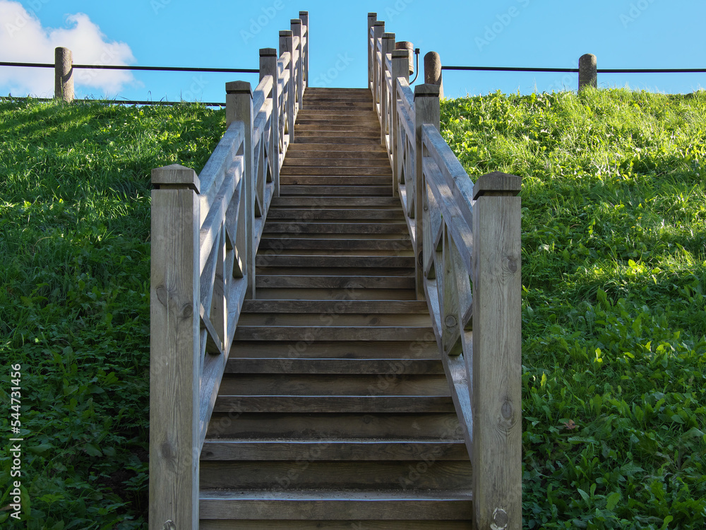 Wooden stairs to the river bank. Kuldiga, Latvia. Selective focus. Wooden stairs to the river bank. Kuldiga, Latvia. Selective focus.