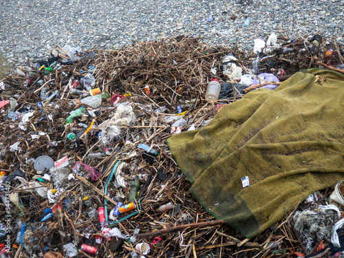   Landfill on the seashore. Depressive mood. Environmental pollution. Pile of garbage photo