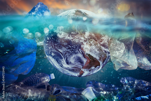 The world floats in the ocean amidst the plastic. Earh provided by NASA photo