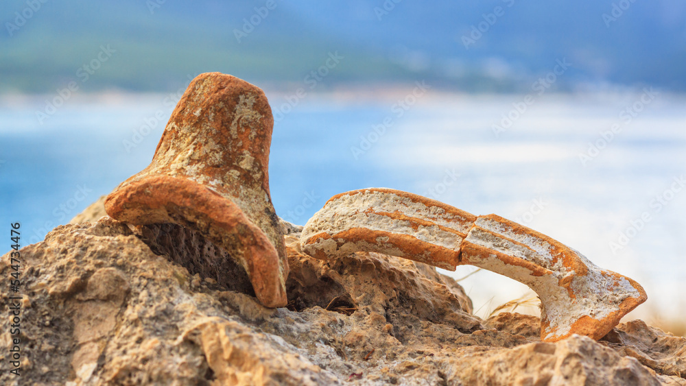 Mediterranean summer landscape - view of the fragments of ancient amphorae closeup on the background of mountains, on the Lycian Way, Antalya Province in Turkey Mediterranean summer landscape - view of the fragments of ancient amphorae closeup on the background of mountains, on the Lycian Way, Antalya Province in Turkey