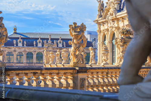 Cityscape - view of a sculptures on the balustrade against the backdrop of the architecture Zwinger Palace complex in Dresden, Germany