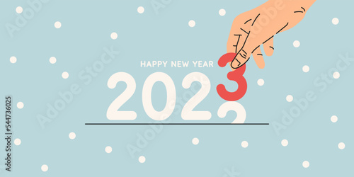 Background with the inscription Happy New Year 2023. A person holds a number in his hand.