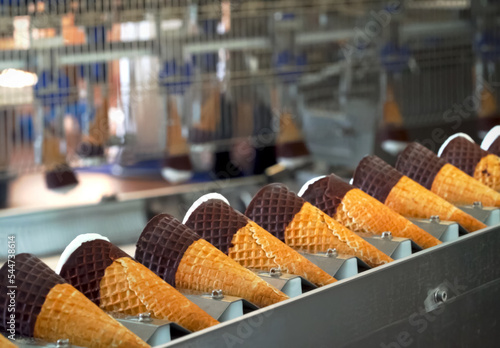 Ice cream cones on conveyor. Ice cream factory.
