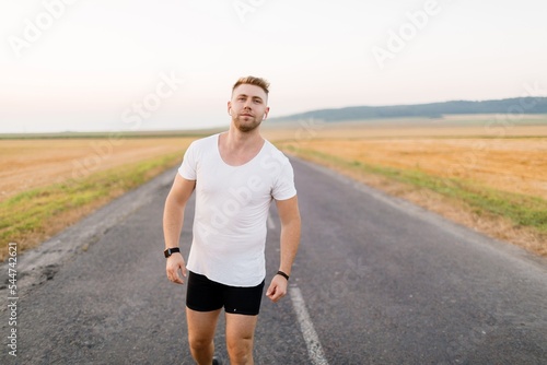 Sporty man running outdoors © Kuz Production