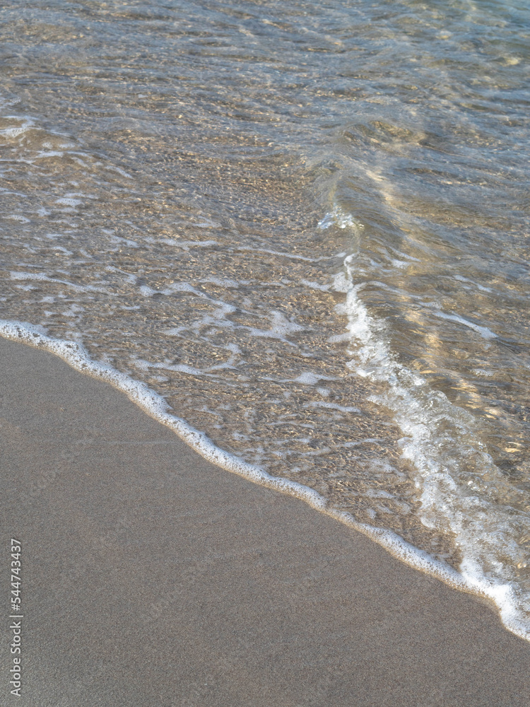 clear water and foam on the sandy beach 