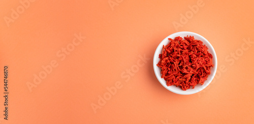 Solanum lycopersicum - Dehydrated dried tomato flakes in the bowl photo
