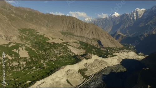 Aerial pan trough hopper glacier during sunrise (golden hour), Pakistan
