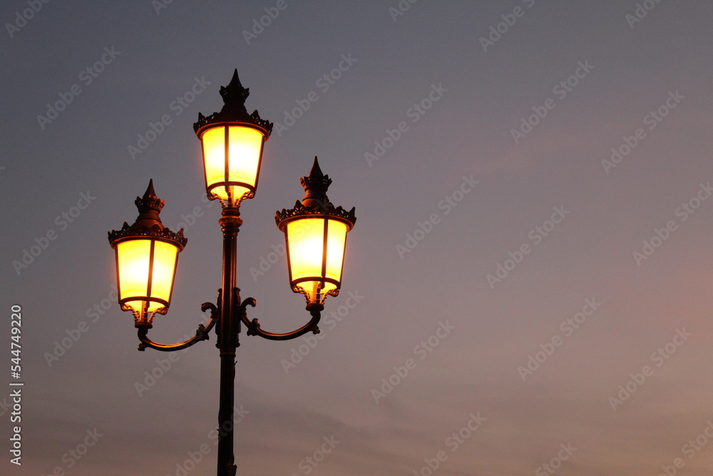 Beautiful vintage style street lamp at sunset