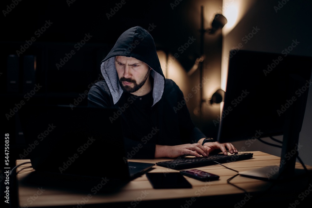 Hacker with computers Hacker with computers