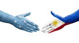 Handshake between Micronesia and Philippines flags painted on hands, isolated transparent image.