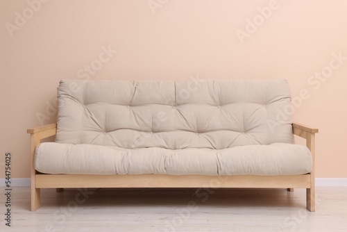 Comfortable sofa near beige wall on floor indoors © New Africa