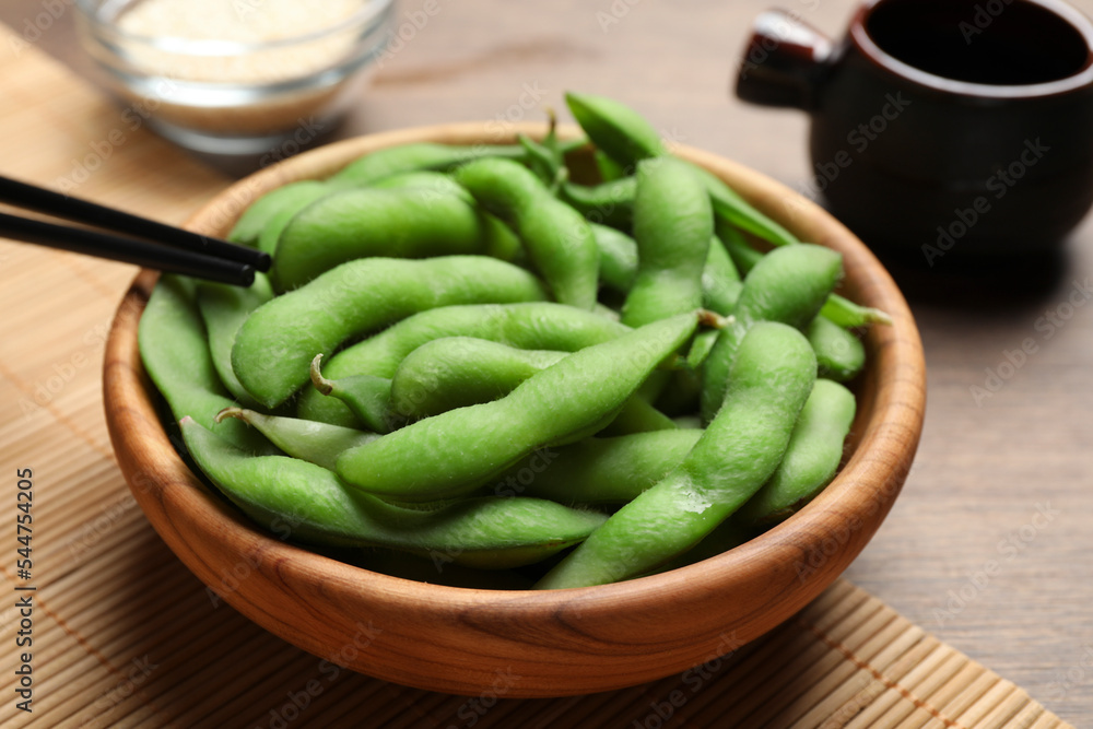 Green edamame beans in pods served on wooden table Green edamame beans in pods served on wooden table