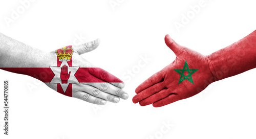 Handshake between Morocco and Northern Ireland flags painted on hands, isolated transparent image. photo