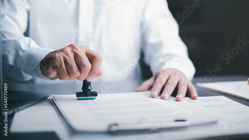 Canvas Print Businessman validates and manages business documents and agreements, signing a b
