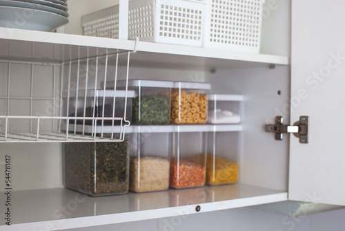 House decor ideas. Storage in the kitchen. Home organization. White shelf and modern interior. photo