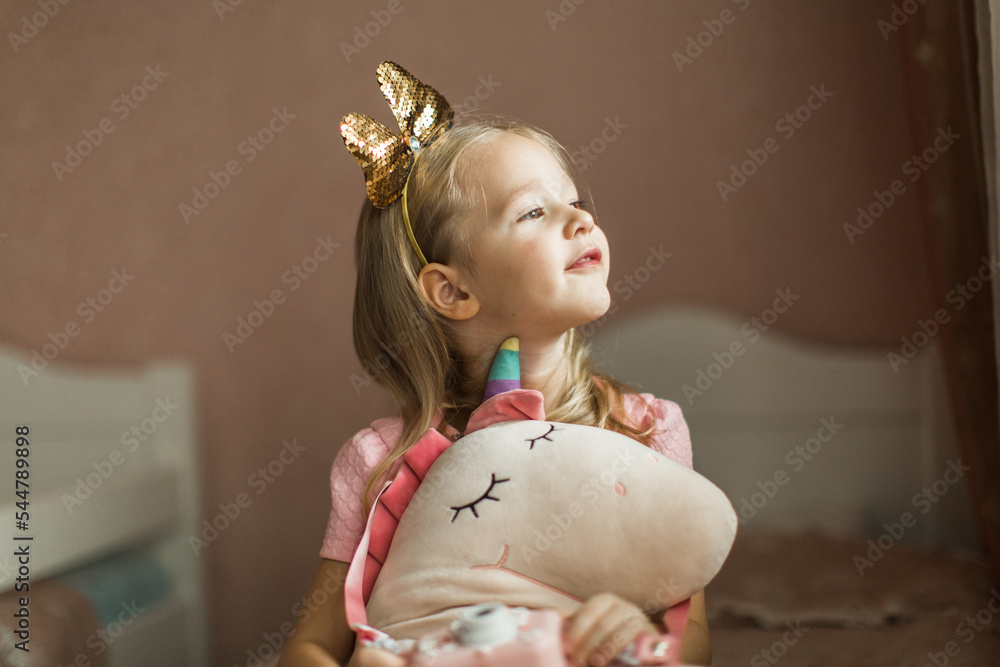 beautiful girl with unicorn in her children's room
