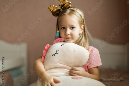 beautiful girl with unicorn in her children's room