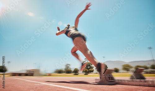 Speed, track start and woman running for marathon race workout, fitness or exercise for leg power action. Health commitment, blue sky flare and fast sports girl, athlete or cardio runner training © L Ismail/peopleimages.com
